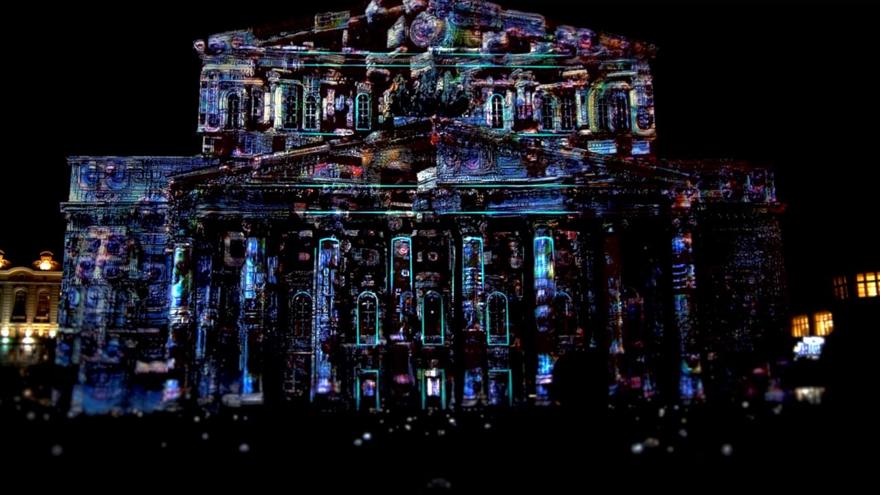 The Bolshoi Theatre in Moscow covered in a dark, textured 3D projection mapping with glowing cracks and colours