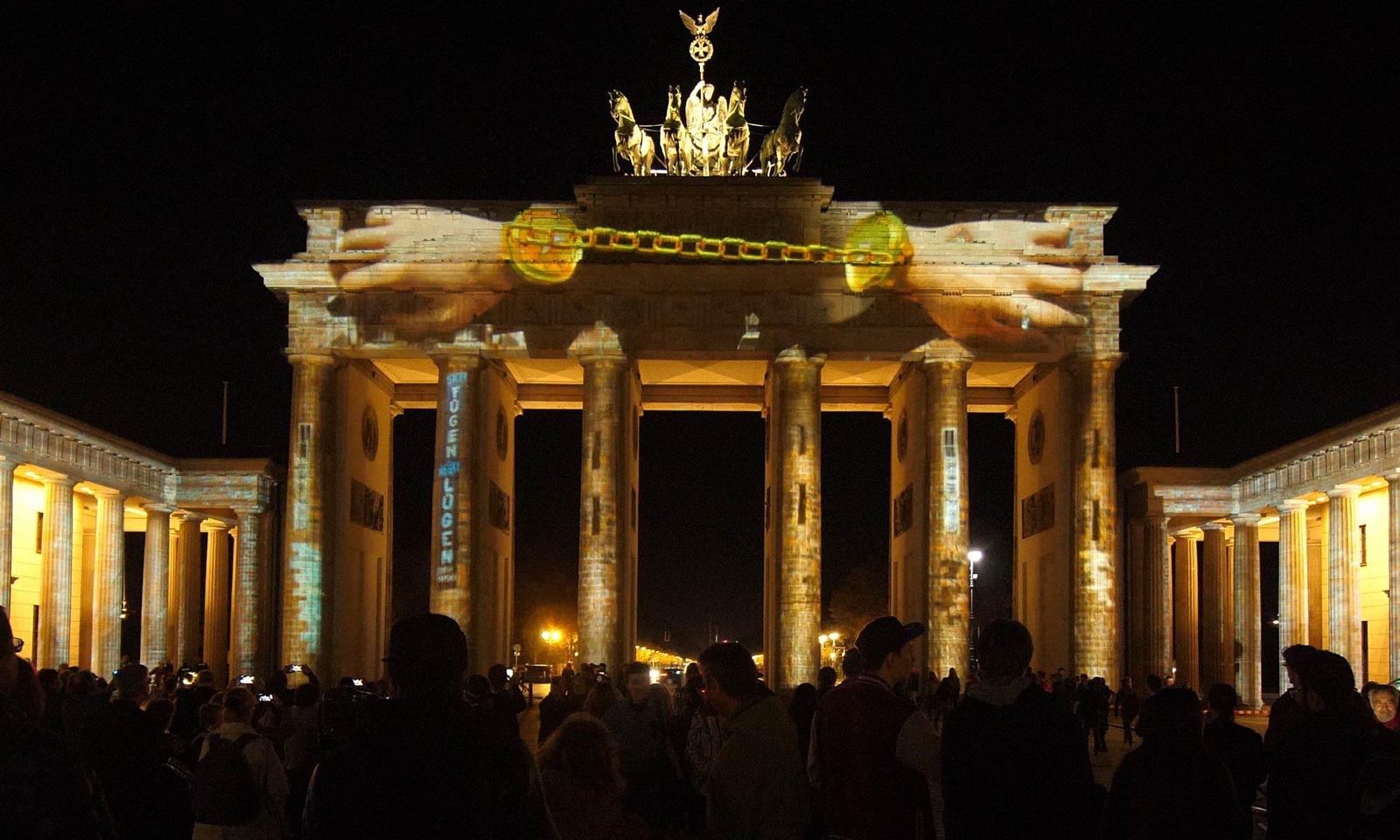 The Brandenburg Gate in Berlin covered in a golden 3D projection mapping during the Festival of Lights