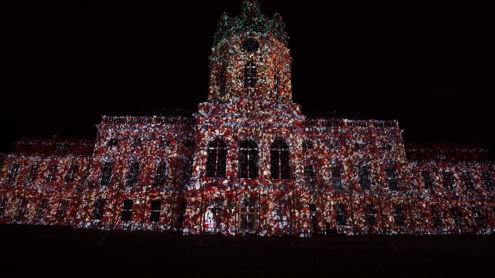 The façade of Charlottenburg Palace in Berlin covered in a red and white ornamental projection mapping during the Festival of Lights