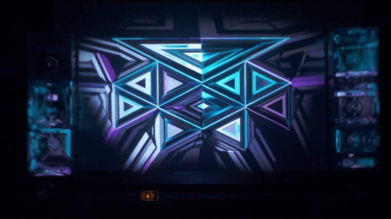 A geometric stage structure inside the Juice Club Hamburg lit by projection-mapped animations