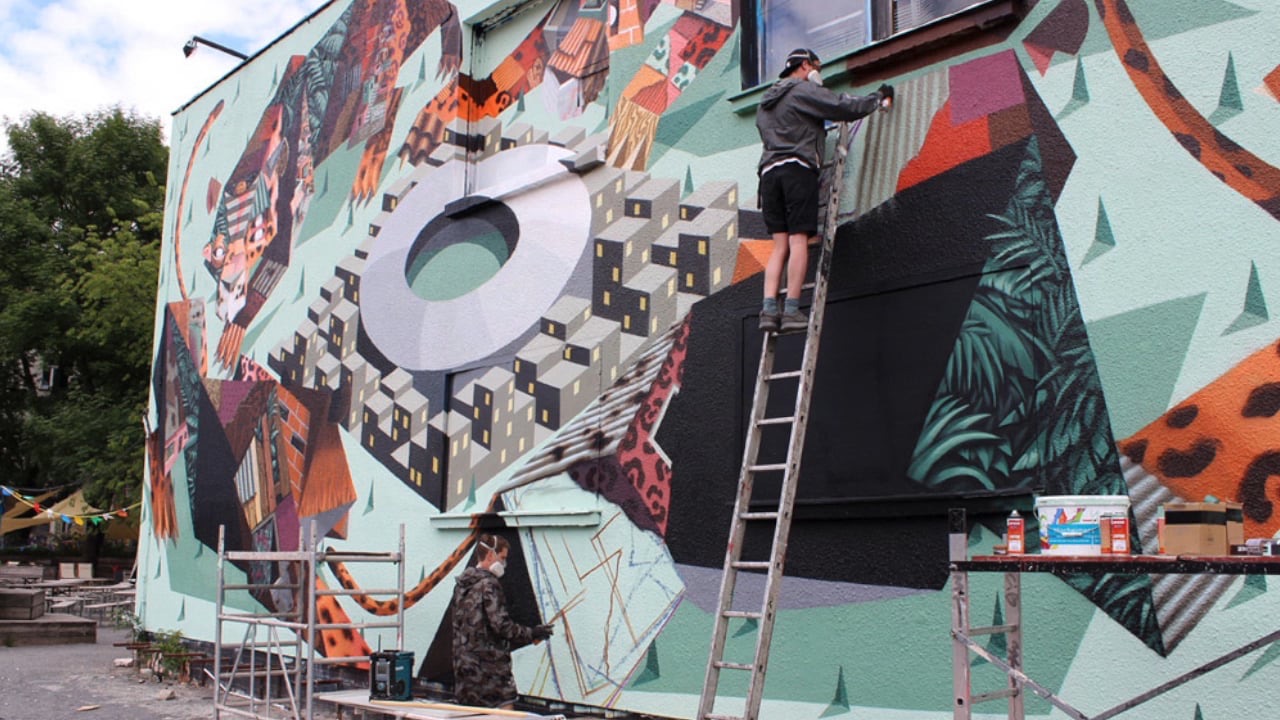 A colourful mural by the artist duo Low Bros on a wall at Urban Spree Berlin, animated by projection mapping