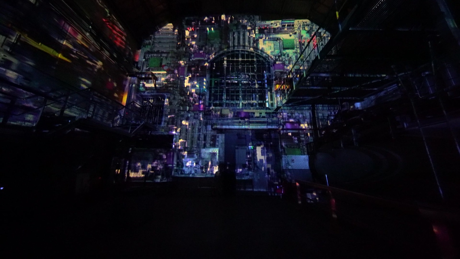 The brick walls of the MaHalla industrial hall in Berlin wrapped in a blue and cyan 270-degree projection mapping