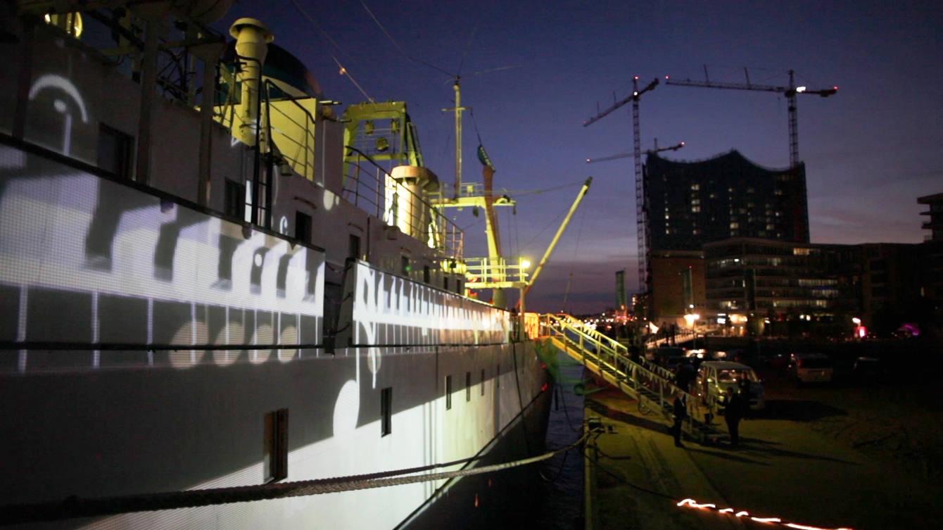 The hull of the ship MS Stubnitz in Hamburg harbour lit by projection mapping during the Elbjazz Festival
