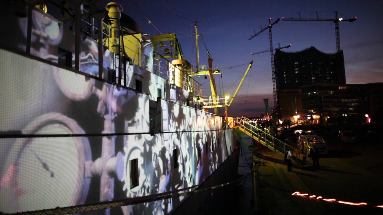 The hull of the ship MS Stubnitz in Hamburg harbour lit by projection mapping during the Elbjazz Festival