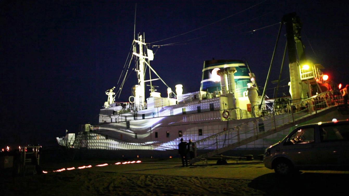 The hull of the ship MS Stubnitz in Hamburg harbour lit by projection mapping during the Elbjazz Festival